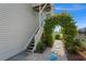 Exterior stairway entrance framed by lush landscaping at 20019 Gulf Blvd # 1, Indian Shores, FL 33785