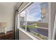 Window view showcases waterfront location with boat docks and surrounding landscaping at 20019 Gulf Blvd # 1, Indian Shores, FL 33785