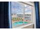 Scenic window view showcasing a private pool, waterfront, and inviting docks on a sunny day at 20019 Gulf Blvd # 1, Indian Shores, FL 33785