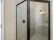 Primary bathroom with a tiled shower with a glass door, and neutral colored tiles at 203 Montara Dr, Seffner, FL 33584