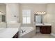 Bathroom features dual sinks, a garden tub with tile surround, and a window with shutters at 203 Montara Dr, Seffner, FL 33584