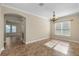 Spacious dining room featuring tile floors, crown molding, and a stylish chandelier at 203 Montara Dr, Seffner, FL 33584