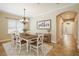 Bright dining room features stylish chandelier, 'gather' sign, and view into entryway at 203 Montara Dr, Seffner, FL 33584