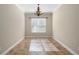 Clean, bright dining room featuring tile floors, a decorative chandelier, and large window at 203 Montara Dr, Seffner, FL 33584
