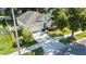 Aerial front view of the home, showcasing the driveway, landscaping, and well-maintained lawn at 203 Montara Dr, Seffner, FL 33584