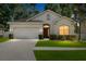 Charming single-story home with a manicured lawn, a two-car garage, and a welcoming entrance at 203 Montara Dr, Seffner, FL 33584