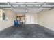 Attached garage with a concrete floor, water heater, and extra storage space with a door leading inside at 203 Montara Dr, Seffner, FL 33584