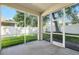 Relaxing screened-in lanai offering views of the fenced backyard and lush greenery, perfect for outdoor living at 203 Montara Dr, Seffner, FL 33584