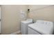 Laundry room featuring modern washer and dryer with wire shelving for storage at 203 Montara Dr, Seffner, FL 33584