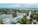 Aerial view of homes with light roofs, a calm bay, and a view of the ocean at 215 18Th Ave, Indian Rocks Beach, FL 33785