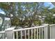 Balcony with a view of lush greenery and serene waterfront at 215 18Th Ave, Indian Rocks Beach, FL 33785