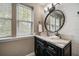 Bathroom featuring dark cabinets, modern fixtures, and natural light from the window at 215 18Th Ave, Indian Rocks Beach, FL 33785