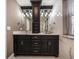 Bathroom with a modern vanity with double sinks, stylish light fixtures, and decorative mirror at 215 18Th Ave, Indian Rocks Beach, FL 33785