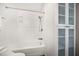 Bathroom features sleek white tiled shower, integrated shelving, and a modern cabinet at 215 18Th Ave, Indian Rocks Beach, FL 33785