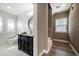 Elegant bathroom featuring a dark vanity with a white countertop, an oval mirror and decorative accents at 215 18Th Ave, Indian Rocks Beach, FL 33785