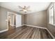 Bedroom with ceiling fan, wood floors and neutral paint color; access to additional rooms at 215 18Th Ave, Indian Rocks Beach, FL 33785