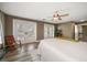 Spacious bedroom showcasing wood floors, ceiling fan, and sliding glass doors leading to a balcony at 215 18Th Ave, Indian Rocks Beach, FL 33785