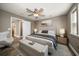 Bedroom with a ceiling fan, natural light from the window, and a comfortable bed with bench at 215 18Th Ave, Indian Rocks Beach, FL 33785