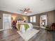 Inviting bedroom featuring wood floors, ceiling fan, large mirror, and decorative furnishings at 215 18Th Ave, Indian Rocks Beach, FL 33785