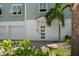 Home exterior featuring the front door, garage, and neatly maintained landscaping at 215 18Th Ave, Indian Rocks Beach, FL 33785