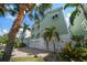 Charming waterfront home with a paved driveway, tropical landscaping, and two-car garage at 215 18Th Ave, Indian Rocks Beach, FL 33785