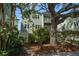 Exterior angle featuring an attractive two-story home with mature trees and lush plants at 215 18Th Ave, Indian Rocks Beach, FL 33785
