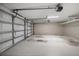 Spacious two-car garage with an automatic door, overhead lighting, and ample room for parking and storage at 215 18Th Ave, Indian Rocks Beach, FL 33785
