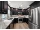 Modern kitchen featuring stainless steel appliances, granite countertops, and wooden cabinets at 215 18Th Ave, Indian Rocks Beach, FL 33785