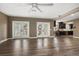 Open-concept living area featuring hardwood floors and access to balcony through double doors at 215 18Th Ave, Indian Rocks Beach, FL 33785