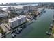 Aerial view of the waterfront condo building with a private marina and community pool at 223 Island Way # 7F, Clearwater Beach, FL 33767