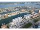 A waterfront condo complex and private homes are shown from an aerial view with private boat docks on the harbor at 223 Island Way # 7F, Clearwater Beach, FL 33767