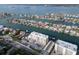 An aerial view shows a waterfront condo and private homes with boat docks and neighborhood pool on a sunny day at 223 Island Way # 7F, Clearwater Beach, FL 33767