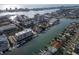 Expansive aerial view of waterfront condos and private homes with boat docks on the harbor and ocean backdrop at 223 Island Way # 7F, Clearwater Beach, FL 33767