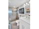 Well-lit bathroom featuring a glass shower and modern vanity with a stylish mirror at 223 Island Way # 7F, Clearwater Beach, FL 33767