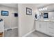 Well-lit bathroom featuring neutral paint, tile flooring, a white vanity, and coastal-themed décor at 223 Island Way # 7F, Clearwater Beach, FL 33767