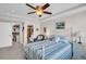 Bedroom featuring a ceiling fan, seating area, closet and attached bathroom at 223 Island Way # 7F, Clearwater Beach, FL 33767