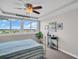 Bright bedroom featuring floor-to-ceiling windows, coastal decor, and water views at 223 Island Way # 7F, Clearwater Beach, FL 33767