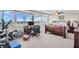 Bright bedroom with large windows showcasing city views, a cozy bed, and a functional work-from-home setup at 223 Island Way # 7F, Clearwater Beach, FL 33767