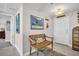 Inviting entryway with neutral paint, tile floor, a wooden bench, and coastal decor at 223 Island Way # 7F, Clearwater Beach, FL 33767