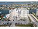 Waterfront condo building featuring covered parking, a manicured lawn, and beautiful water views at 223 Island Way # 7F, Clearwater Beach, FL 33767
