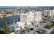 Elegant condo building featuring a pool, boat slips, and well-maintained landscaping at 223 Island Way # 7F, Clearwater Beach, FL 33767