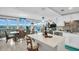 Open-concept living space combining kitchen, dining, and living room, with views of the Intracoastal Waterway at 223 Island Way # 7F, Clearwater Beach, FL 33767