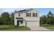 Charming two-story home with a neatly landscaped front yard and attached two car garage at 2273 Blue Grosbeak Pl, Wimauma, FL 33598