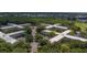 Overhead view of the condo complex, showcasing its expansive layout, mature trees, and proximity to the community at 2441 Persian Dr # 61, Clearwater, FL 33763
