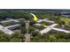 Aerial view of condo complex, surrounded by lush greenery and mature trees, providing a serene and private setting at 2441 Persian Dr # 61, Clearwater, FL 33763