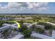 Community aerial view highlighting lush landscaping, golf course and community pond at 2441 Persian Dr # 61, Clearwater, FL 33763