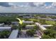 Aerial view of the complex featuring lush landscaping, ample parking, and mature trees at 2441 Persian Dr # 61, Clearwater, FL 33763
