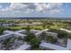 This aerial shows the community, golf course, and pond amid lush landscaping at 2441 Persian Dr # 61, Clearwater, FL 33763