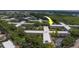 Aerial view of the complex featuring lush landscaping, ample parking, and mature trees at 2441 Persian Dr # 61, Clearwater, FL 33763