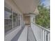 Large balcony with white railings and windows at 2441 Persian Dr # 61, Clearwater, FL 33763